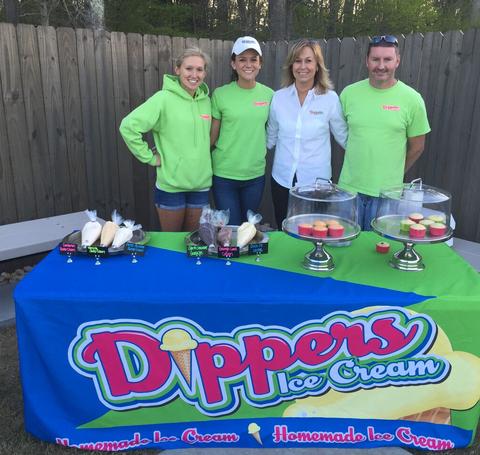 The Dippers Staff Standing Behind a Dessert Table