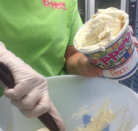 A person scooping ice cream.