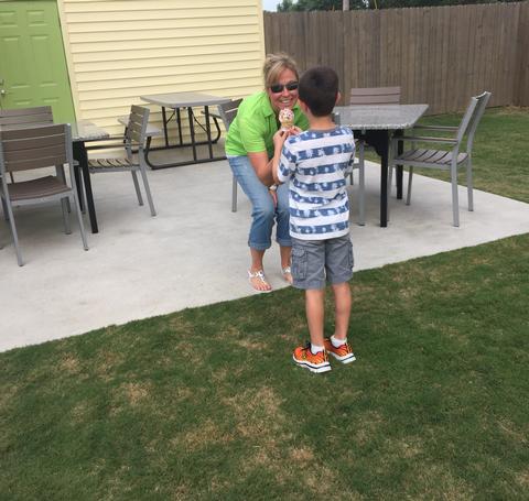 A child getting an ice cream cone from staff.